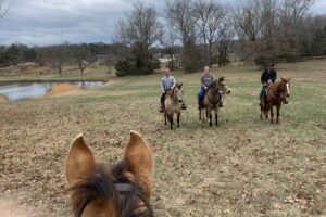 Trail riders near pond Trail riders near pond