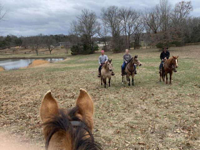 Trail riders near pond