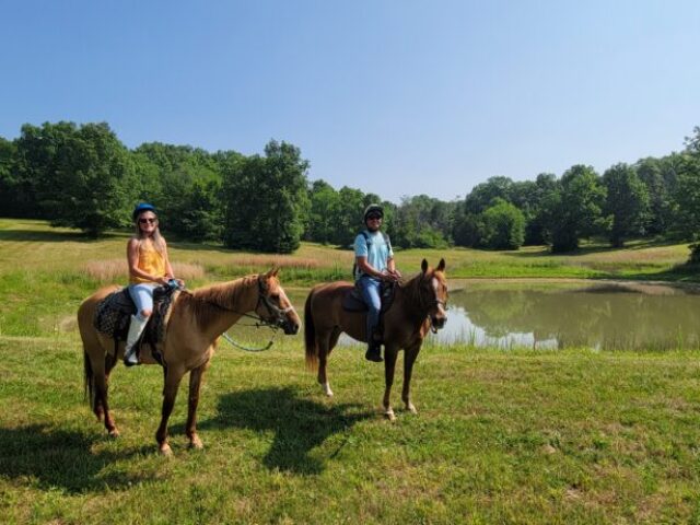 2 riders by pond